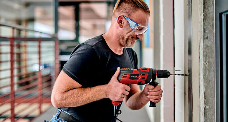 man with an Einhell impact driller